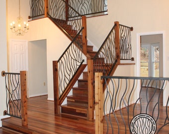 May include: A wooden staircase with black metal railings featuring a wave-like design. The railings are made by Cam Harris Art Inc. Est. 1985.