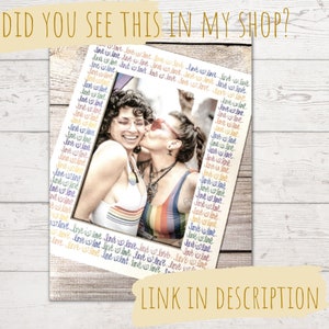 May include: A framed photograph featuring two smiling people, one kissing the other on the cheek. The frame is decorated with the words "love is love" in a rainbow pattern. The image is on a wooden background, with the text "DID YOU SEE THIS IN MY SHOP?" and "LINK IN DESCRIPTION".