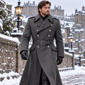 May include: A charcoal grey double-breasted wool overcoat featuring a wide lapel, silver-toned buttons, and a matching fabric belt with a rectangular buckle. The coat includes shoulder epaulets and is worn with black leather gloves.
