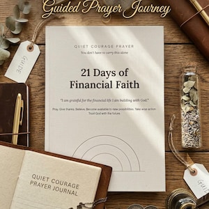 May include: A beige book titled 21 Days of Financial Faith with a rainbow graphic, accompanied by a brown leather journal labelled Quiet Courage Prayer Journal, a metal cross necklace, two coins, a glass vial of dried herbs, and a gold pen.