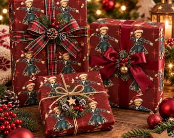May include: Three rectangular gift boxes wrapped in dark red paper featuring a repeating pattern of a character in a suit and Santa hat. The boxes are decorated with plaid or solid ribbons, pine sprigs, berries, pinecones, and a small bell.