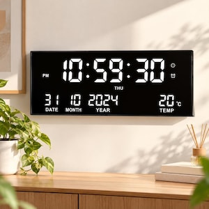 May include: A rectangular black digital wall clock with a large white LED display showing the time 10:59:30 PM, the day THU, the date 31 10 2024, and a temperature of 20 degrees Celsius, featuring icons for a clock and an alarm.
