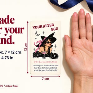 May include: A rectangular card measuring 2.76 by 4.73 inches featuring the text YOUR ALTER EGO and an illustration of a person in a wide-brimmed hat and sunglasses holding a cocktail. The card includes the text EVERY WOMAN HAS A SECRET ALTER EGO and a prompt asking to describe the alter ego.