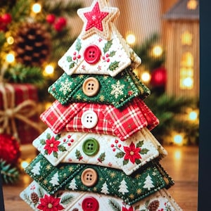 May include: A fabric Christmas tree ornament featuring stacked triangular layers of quilted fabric in red, green, and cream colors. Each layer is adorned with a round button and patterns of poinsettias, pinecones, and snowflakes.