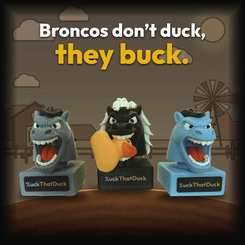 May include: Three horse head figurines on rectangular bases with the text %uckThatDuck. The left is gray, the center is black with a white mane holding an orange rubber duck, and the right is light blue. Text above reads: Broncos don't duck, they buck.