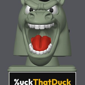 May include: A sage green horse head figurine with a black mane, wide open mouth, white teeth, and a bright red tongue. The base features a black rectangular plaque with the white and yellow text %uckThatDuck printed on the front surface.