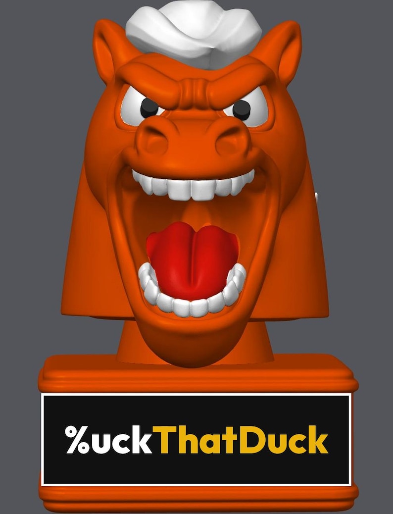 May include: An orange horse head figurine with a white mane, wide-open mouth, red tongue, and white teeth. The base is a rectangular orange block featuring a black plaque with the white and yellow text %uckThatDuck printed on the front.