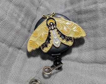 Carrete de insignia de polilla con pinza de cocodrilo
