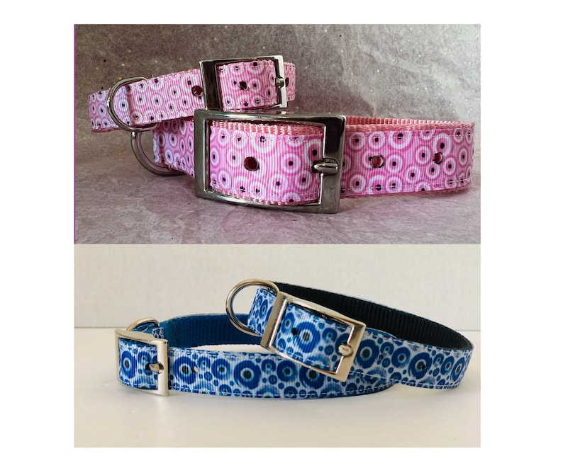 May include: Two dog collars. One is pink with a white and pink circular pattern, and the other is blue with a white and blue circular pattern. Both collars have silver metal hardware.