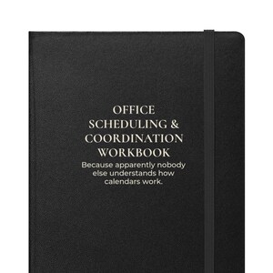 May include: A black hardcover notebook with a vertical elastic closure band. The cover features white text that reads: OFFICE SCHEDULING & COORDINATION WORKBOOK. Because apparently nobody else understands how calendars work.