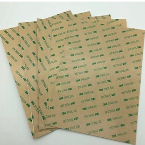 May include: A stack of brown adhesive sheets with green text that reads "3M 300LSE" and "3M 300WC".