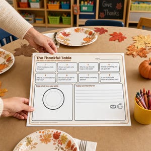 May include: A white paper activity placemat titled The Thankful Table with eight numbered conversation questions, a section to draw what is on your plate, and a section to write what you are thankful for, featuring small pumpkin and pie icons.