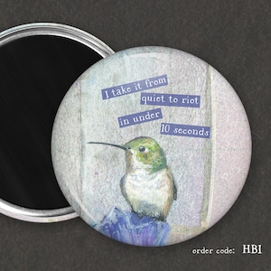May include: A round magnet featuring a watercolor hummingbird illustration. The magnet has text that reads "I take it from quiet to riot in under 10 seconds." The order code "HBI" is also visible.