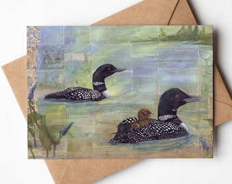 May include: A watercolor painting of two loon birds swimming in a lake. The loon in the foreground has a chick riding on its back. The background is a soft blue and green.