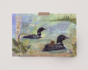 May include: A watercolor painting of two loon birds swimming in a lake. The loon in the foreground has a chick riding on its back. The background is a collage of blue and green watercolor washes.