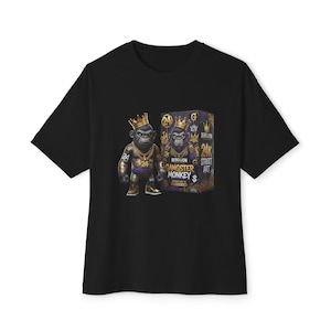 May include: A black t-shirt featuring a graphic print of a gorilla wearing a gold crown and chains next to a box labeled Rebellion Gangster Monkey 24K Street Art. The design includes gold and purple accents with the number 24 and dollar signs.