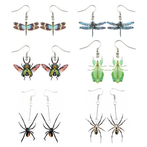 May include: Set of 10 pairs of earrings featuring various insect designs. The earrings are silver-toned and feature a dragonfly, beetle, and spider.