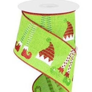 May include: Green and red Christmas ribbon with a repeating pattern of elf legs and hats. The ribbon is 2.5 inches wide and has a wired edge.