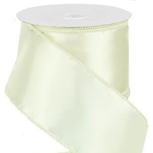May include: A roll of ivory satin ribbon with a wired edge. The ribbon is 2.5 inches wide and is perfect for crafting, gift wrapping, and decorating.