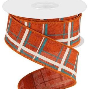 May include: A roll of 2.5 inch wide orange, white and teal plaid ribbon. The ribbon has a woven texture and is ideal for crafting and decorating.