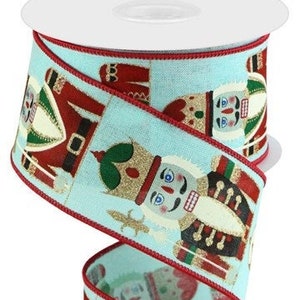 May include: Blue ribbon with a red trim and a repeating pattern of nutcracker figures. The nutcrackers are wearing red, gold, and green costumes.