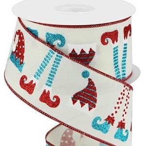 May include: White ribbon with red and blue elf boot and hat designs. The ribbon has a red edge and a glittery finish.