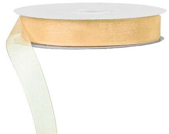 May include: A spool of pale gold sheer ribbon. The ribbon is on a white spool and is curled to the side.