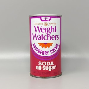 May include: A cylindrical metal soda can featuring a pink and white label with the text Weight Watchers Raspberry Creme Soda no sugar. The design includes an orange flower graphic and states 12 fl oz at the bottom of the front panel.