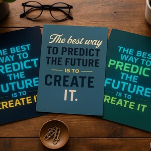 May include: Three motivational posters with the text "The best way to predict the future is to create it." The posters are in shades of blue and green with white and yellow text. A pair of glasses, a pen, a cup of coffee, and a small bowl with paper clips are also on the wooden surface.