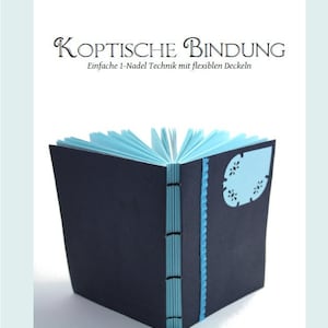 May include: A blue and white book with the title "KOPTISCHE BINDUNG" and the text "Einfache 1-Nadel Technik mit flexiblen Deckeln".