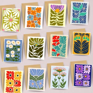 May include: A collection of floral greeting cards with various designs. Each card features a different colorful flower illustration, set against a white background, and paired with a brown envelope. The cards showcase a range of styles, from daisies to abstract floral patterns.