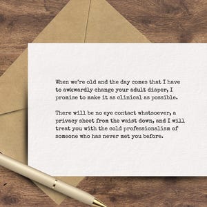 May include: A white greeting card with humorous text, placed on a brown envelope, and a gold pen. The card's text humorously describes the future care of an elderly person. The background is a wooden surface.