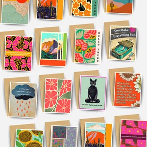 May include: A collection of sixteen rectangular greeting cards featuring diverse graphic illustrations, including desert landscapes, floral patterns, a cat, a sardine tin, and various motivational or humorous text phrases.