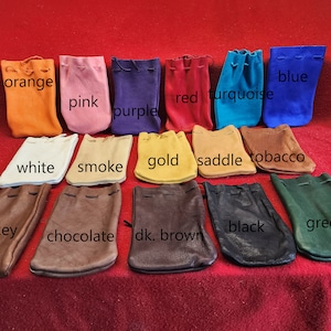 May include: A collection of 14 small leather pouches in various colors, including orange, pink, purple, red, turquoise, blue, white, smoke, gold, saddle, tobacco, whiskey, chocolate, dark brown, black, and green.