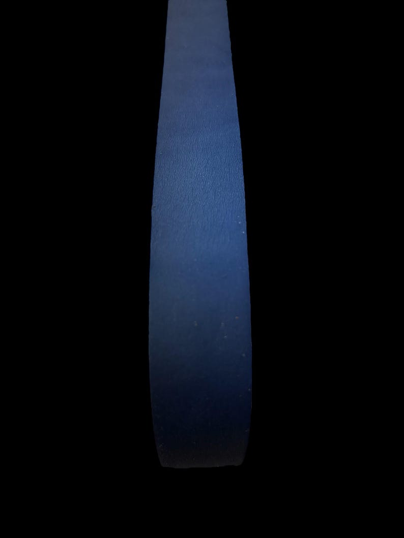 May include: A close-up of a dark blue leather strap.