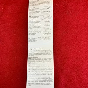 May include: Instructions for threading and using a sewing awl. The awl is a small, handheld tool with a pointed end used for making holes in fabric. The instructions include illustrations showing how to thread the awl and how to make a stitch.