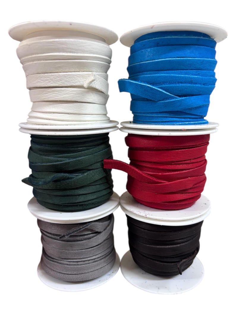 May include: Six spools of leather cord in different colors. The colors are white, blue, red, green, gray, and black.