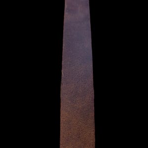 May include: A long, narrow strip of brown leather with a textured surface.