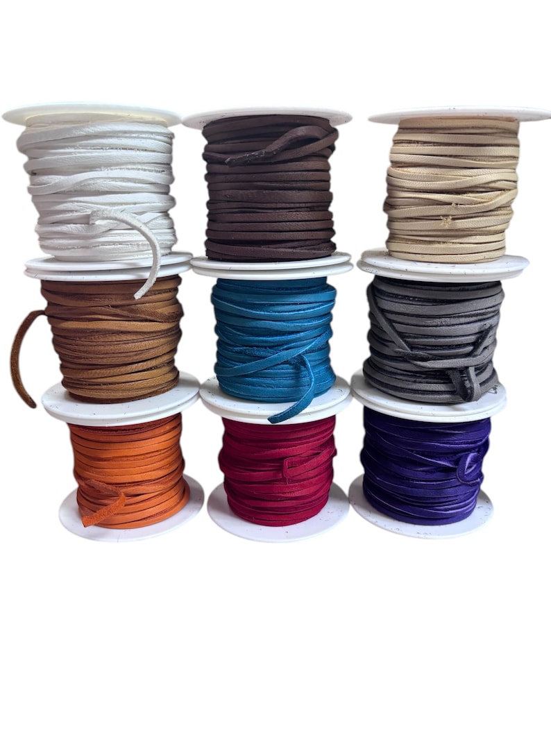 May include: Ten spools of leather cord in various colors, including white, brown, beige, tan, teal, gray, orange, red, and purple. The spools are arranged in three rows.