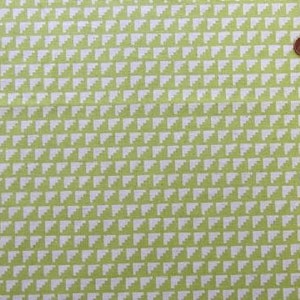 May include: Green fabric with a white geometric pattern of small triangles.