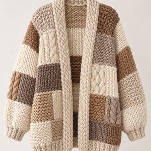 May include: A chunky knit cardigan featuring a patchwork design of cream, beige, and brown squares. The garment includes alternating textures of stockinette, garter, and cable knit patterns with a thick ribbed collar and long sleeves.