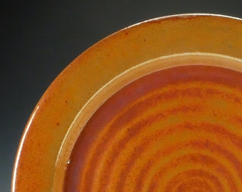 Raku pottery platter with orange crackle glaze.