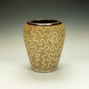 Handmade pottery vessel.  Inlaid clay.