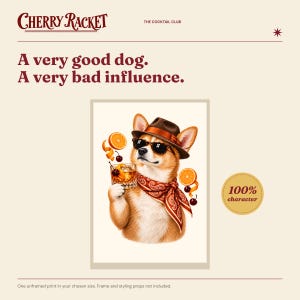 May include: A rectangular art print featuring a dog wearing a brown fedora, sunglasses, and a red paisley bandana. The dog holds a glass of amber liquid with orange slices and cherries. Text reads: Cherry Racket, The Cocktail Club, A very good dog. A very bad influence., 100% character.