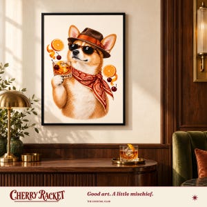 May include: A framed wall art print featuring a Corgi dog wearing a brown fedora, black sunglasses, and a red paisley bandana. The dog holds a glass of amber liquid with ice, surrounded by floating orange slices and cherries.