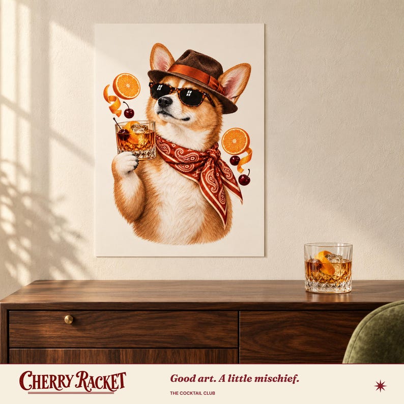 May include: A wall art print featuring a Corgi dog wearing a brown fedora, black sunglasses, and a red paisley bandana. The dog holds a glass of amber liquid with a cherry and orange slice, surrounded by floating orange slices and cherries.
