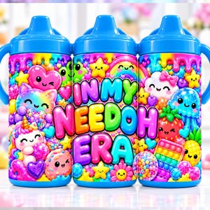 May include: Three blue sippy cups featuring a vibrant, multi-colored graphic print. The design includes cartoon characters like a unicorn, jellyfish, and strawberry, alongside hearts, stars, and a rainbow. The text reads IN MY NEEDOH ERA.