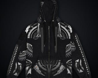 May include: A black zip-up hoodie featuring a white graphic print of mechanical, circular patterns and stylized wing motifs. The garment includes a hood with black drawstrings, a full-length front zipper, and long sleeves with matching geometric designs.