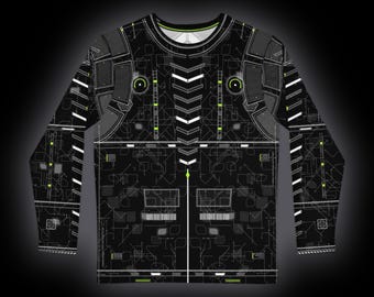 Può includere: Una maglia a maniche lunghe con girocollo nera caratterizzata da un motivo tecnico a circuito stampato in bianco e verde neon. Il design include linee geometriche, strutture a griglia e accenti a chevron su petto e maniche.