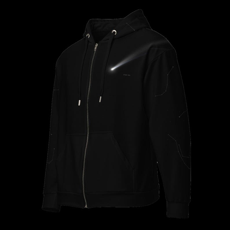 May include: A black zip-up hoodie featuring a silver metallic zipper, a drawstring hood with silver aglets, and a graphic of a white glowing comet on the chest. The sleeves are detailed with faint, thin white lines forming a geometric pattern.